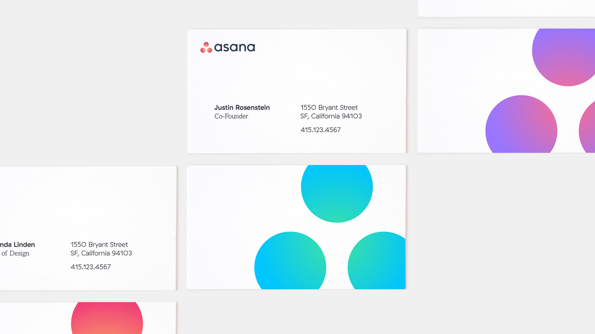Business cards with the Asana logo and textures on them.