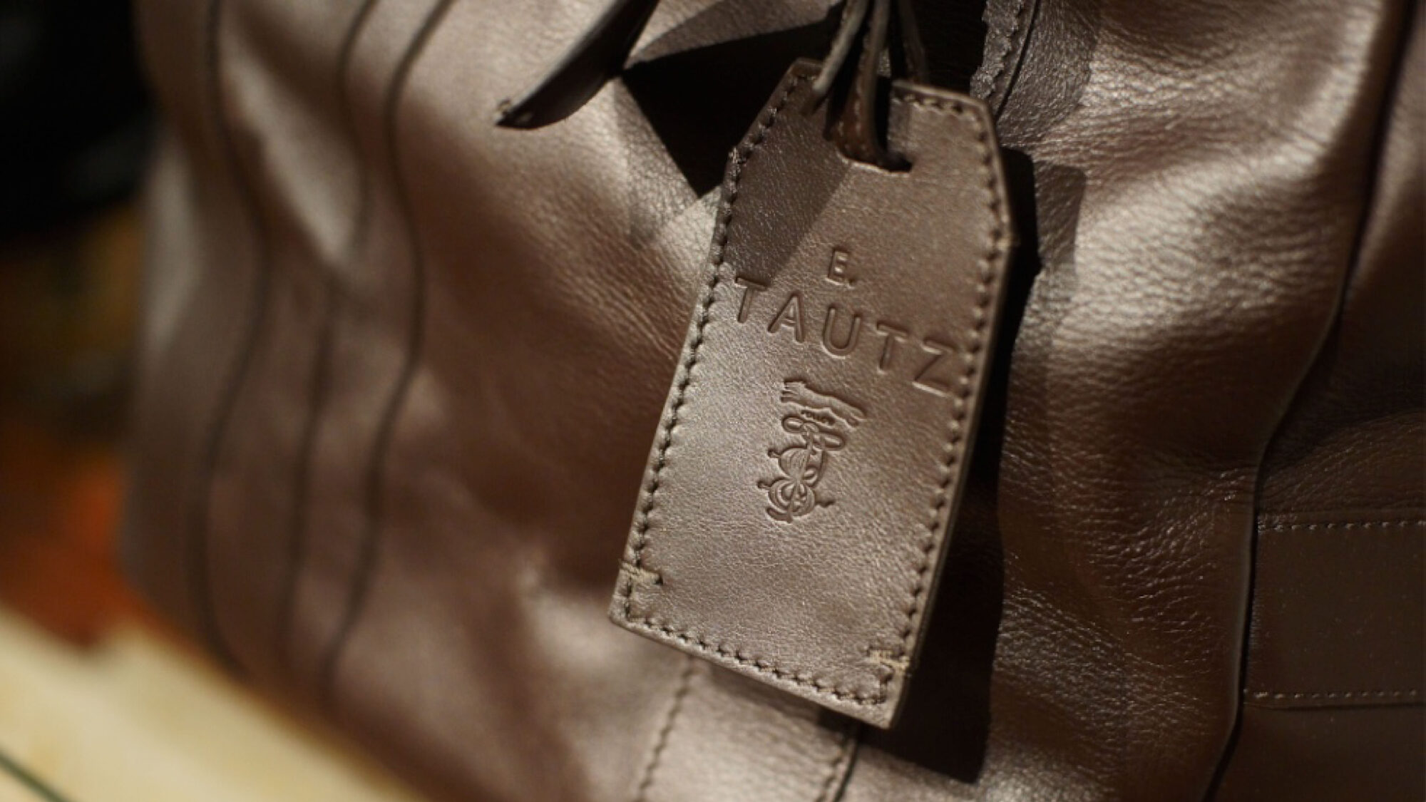 A brown leather bag featuring the brand.