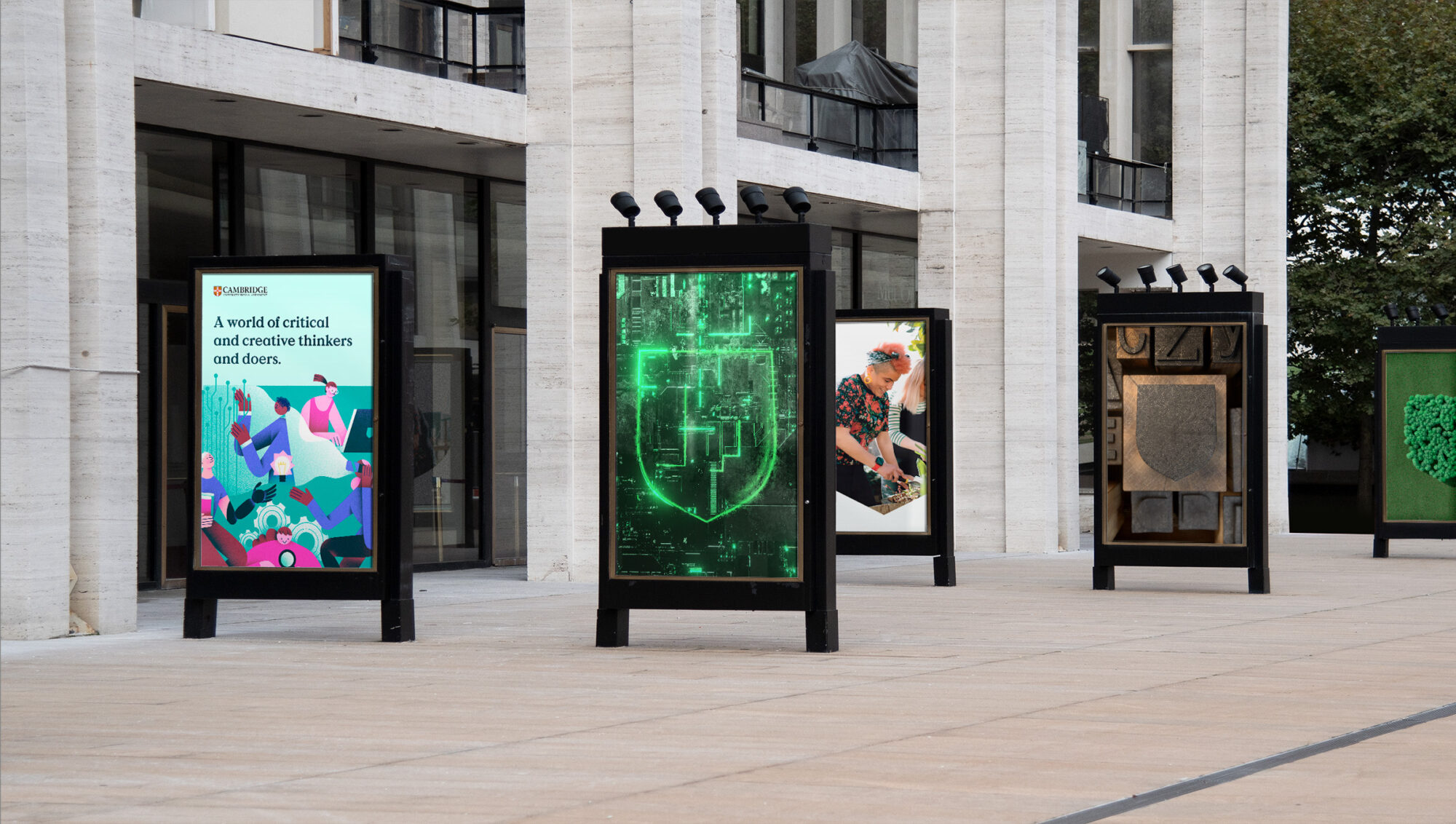 An out of home photo of five billboards showing different Cambridge university marketing materials.