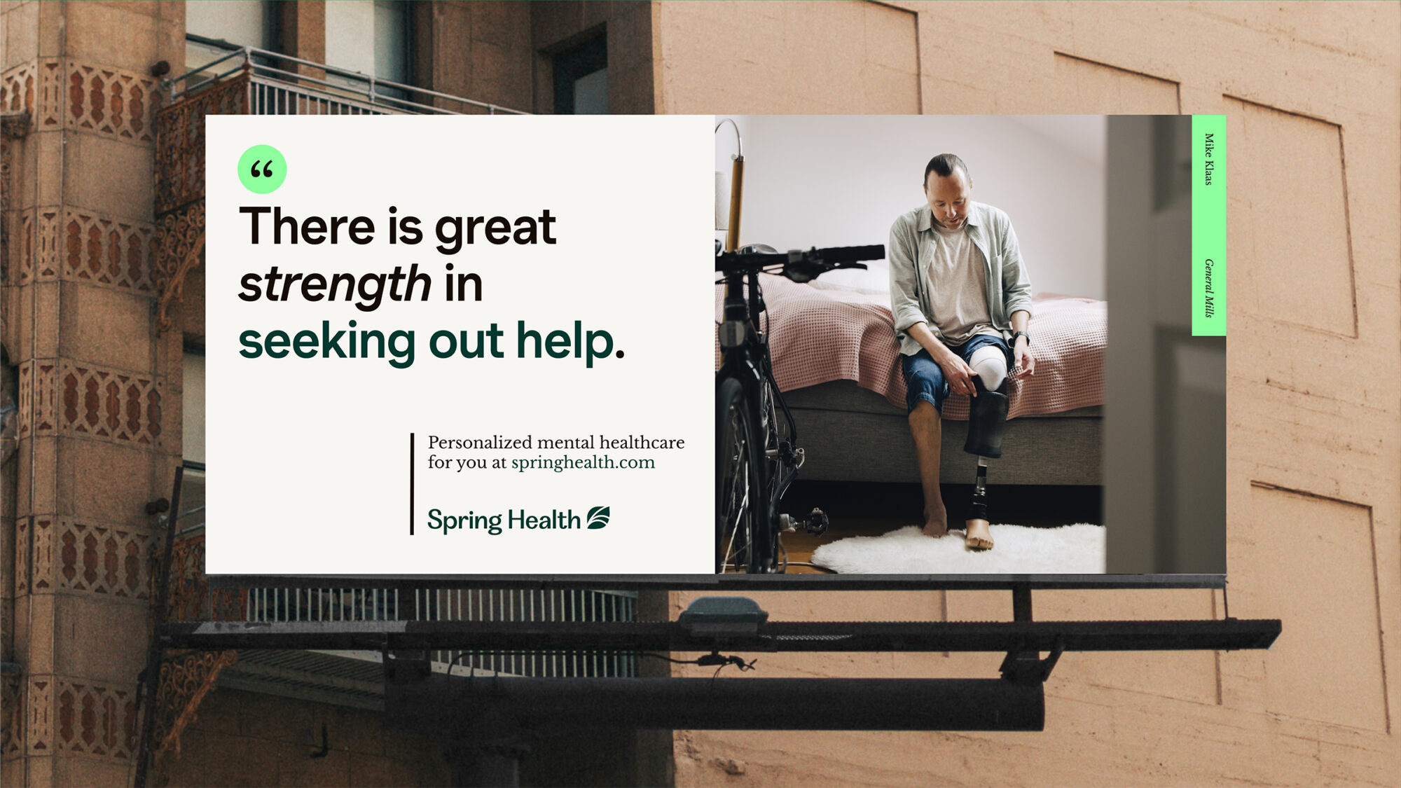 An out of home billboard with a graphic Spring Health poster featuring a man attaching a prosthetic leg and the title “There is great strength in seeking out help.”